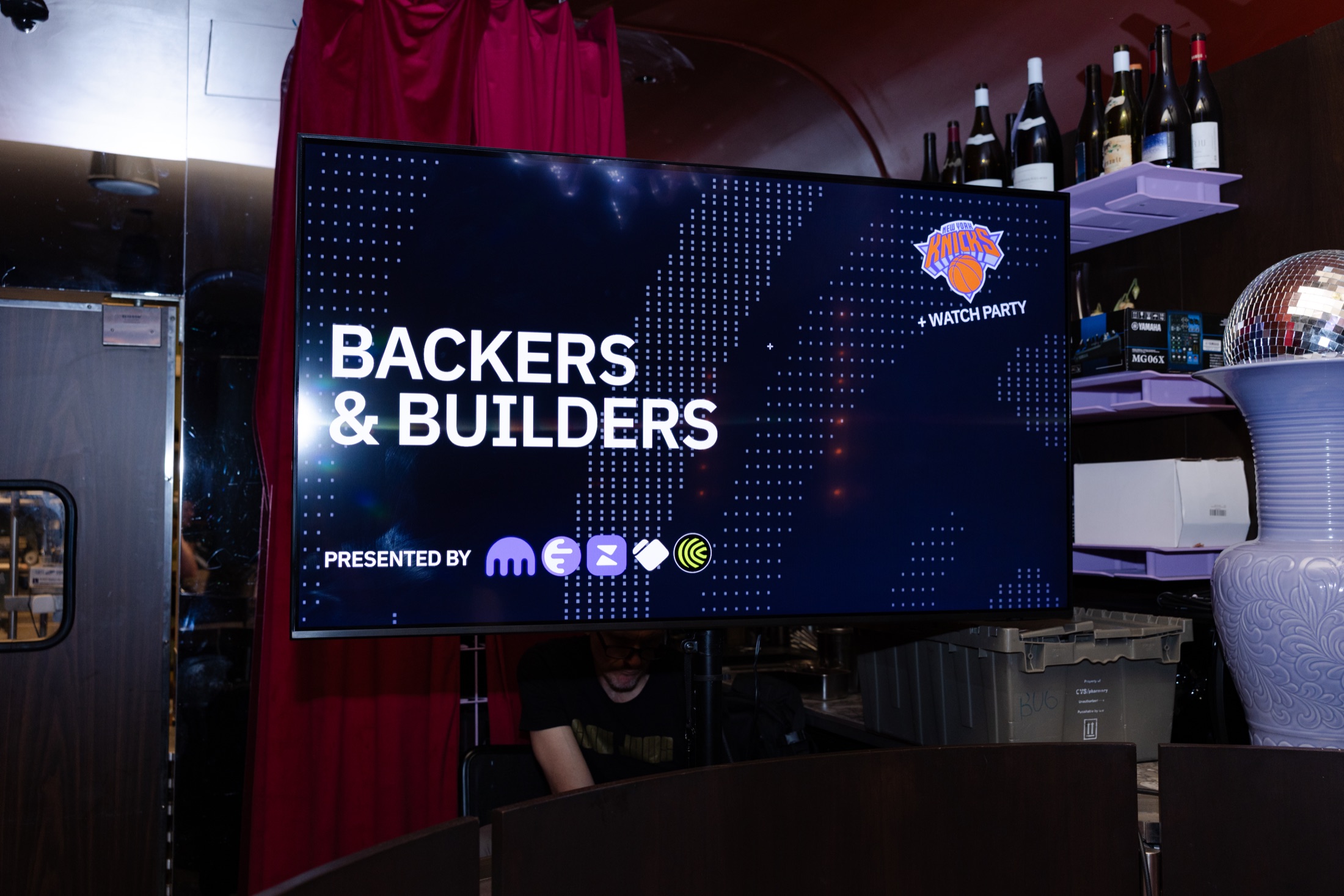 A screen displaying the Backers & Builders event title and presenting partner logos
