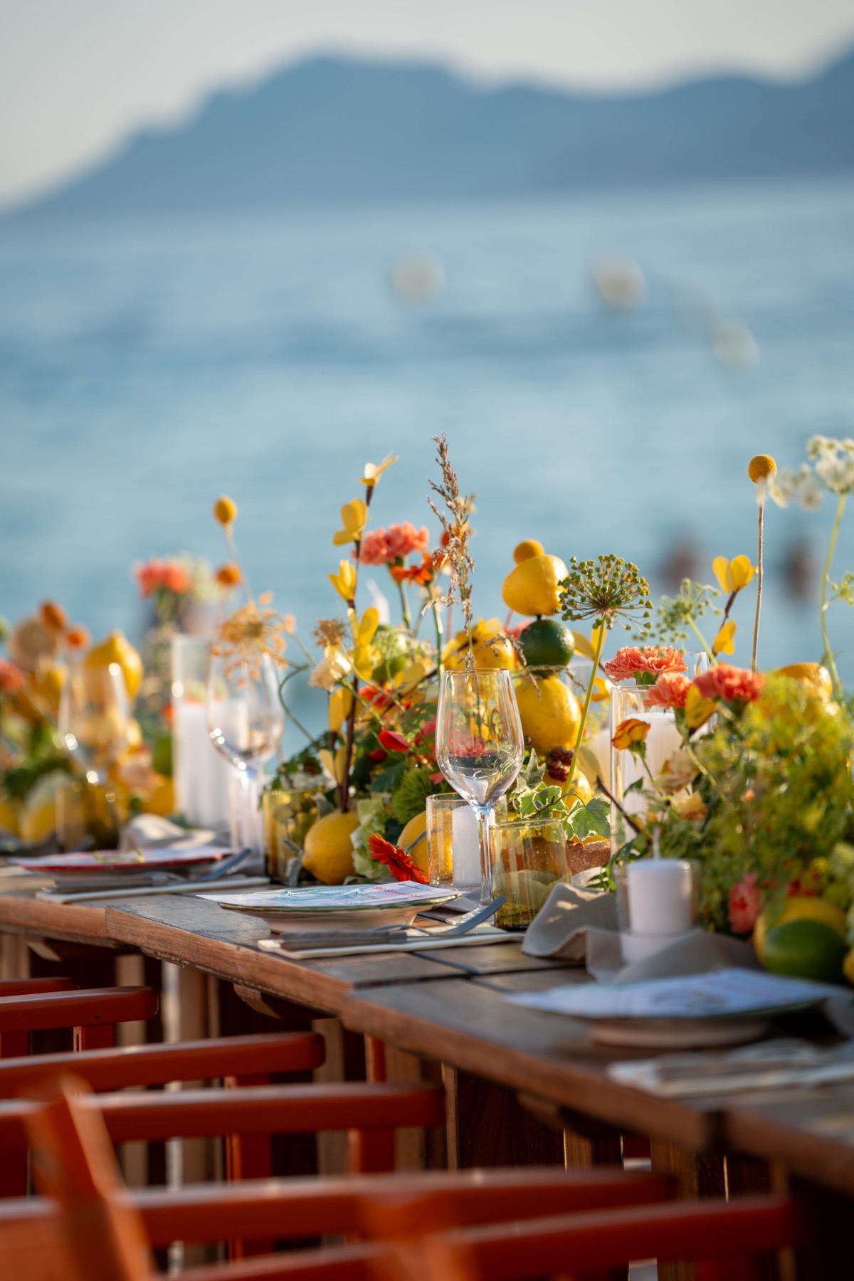 Cannes table detail with lemons, flowers, candles, and glassware