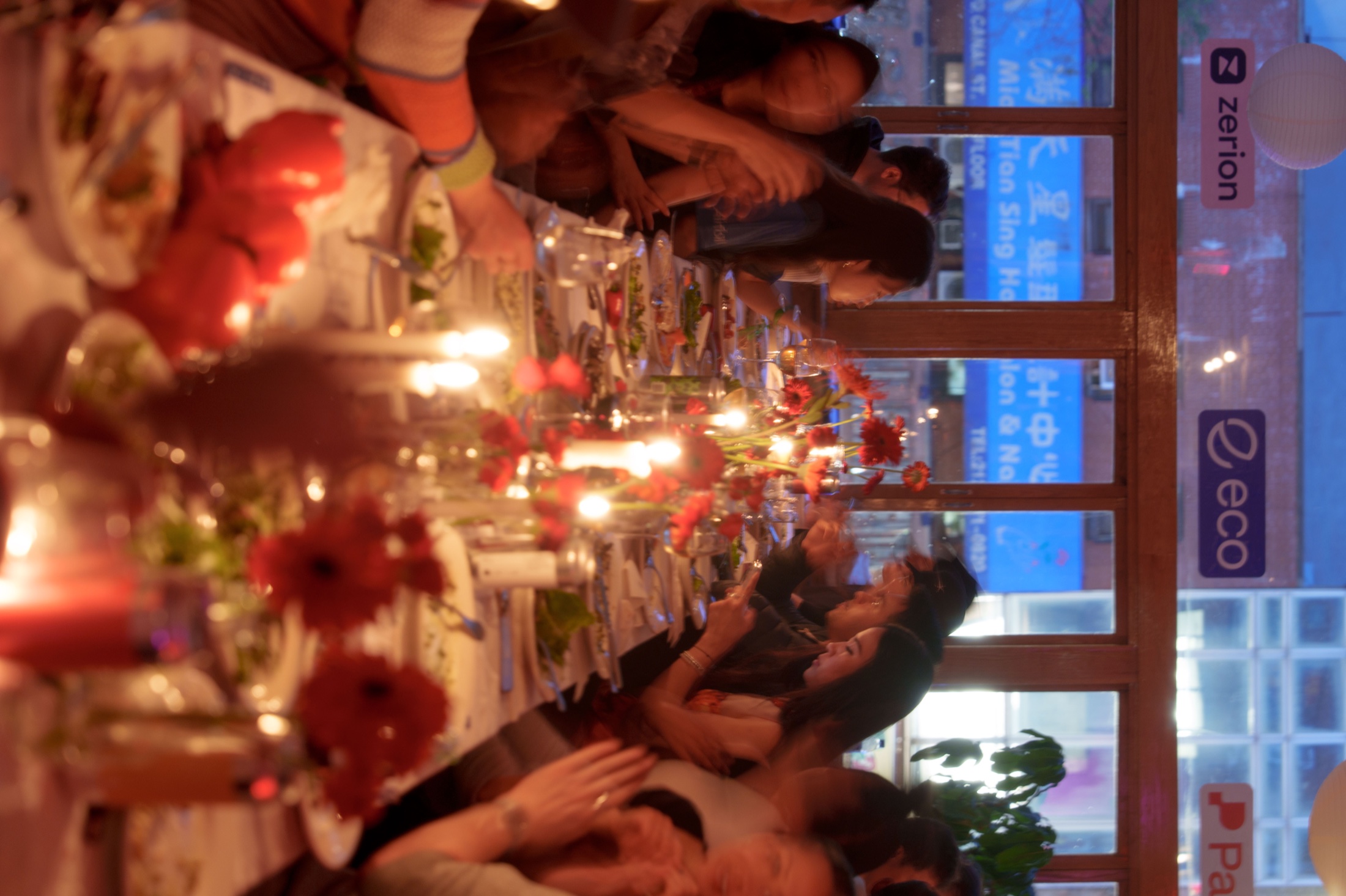 Supper club guests gathered around a candlelit table