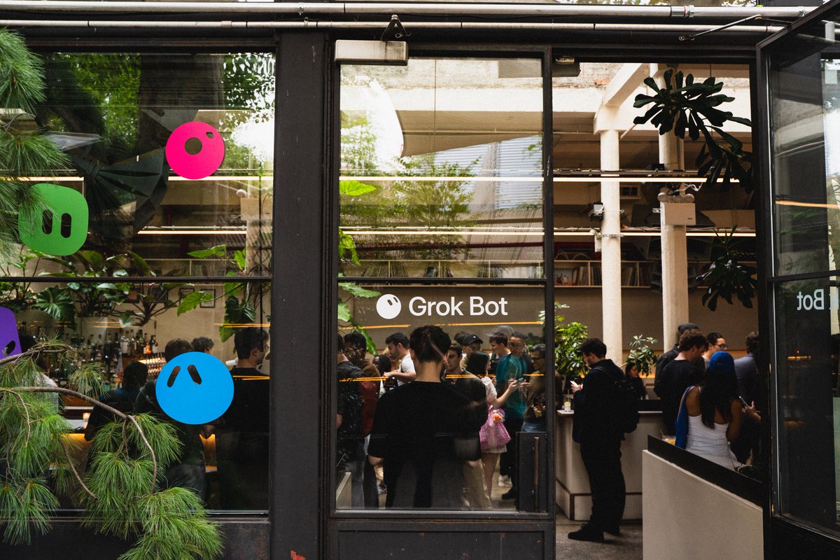 Guests gathering behind the Grok Bot-branded windows at Builders Night in New York