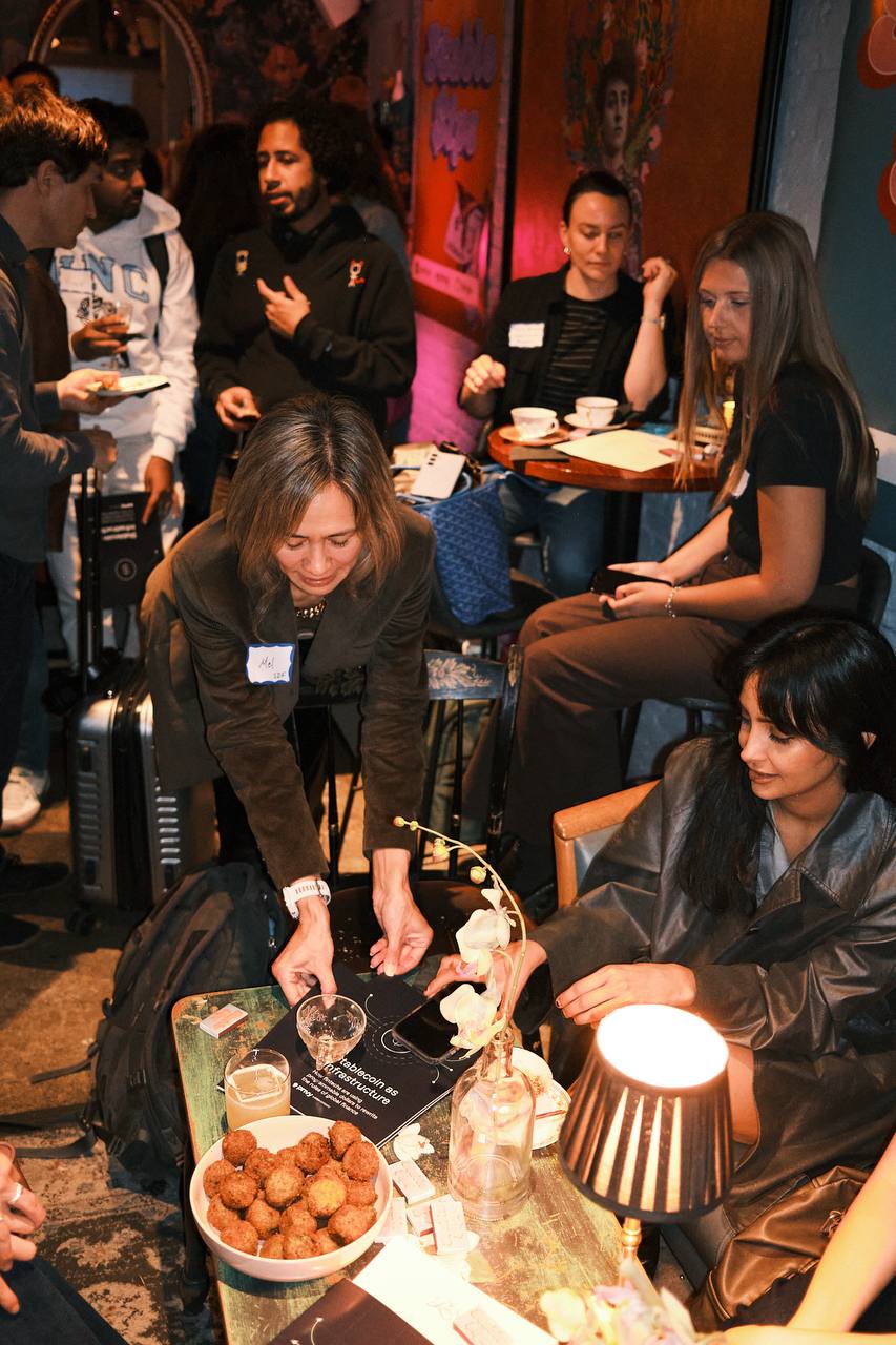 Guests talking over drinks and food at Stable Sips in New York