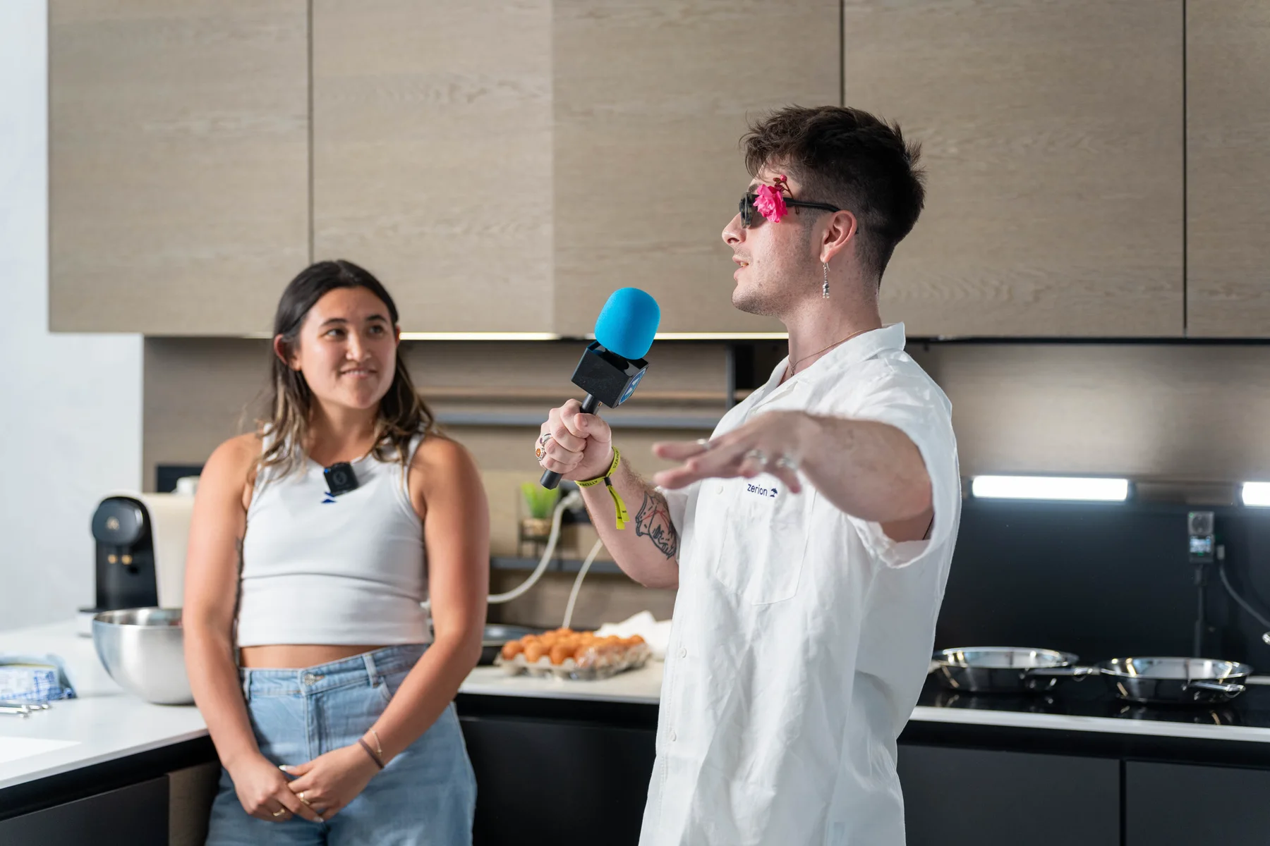 Two people filming an interview with a blue microphone at Zerion Beach House